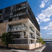 An exterior view of the apartments. - An apartment, architecture, building, commercial building, condominium, corporate headquarters, facade, home, house, mixed use, neighbourhood, property, real estate, residential area, sky, black