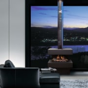 Freestanding gas fireplace in lounge with black sofa heat, interior design, product design, black, gray