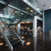 Staircase in office, with glass balustrades, landings and architecture, glass, interior design, lobby, black, gray