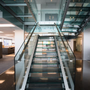 Staircase in office, with glass balustrades, landings and architecture, building, daylighting, glass, handrail, stairs, structure, black, gray