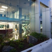 Exterior of commercial building showing extensive glazing along apartment, architecture, building, condominium, home, house, interior design, real estate, gray