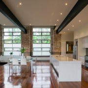 A view of the kitchen and dining areas, architecture, ceiling, countertop, daylighting, floor, flooring, hardwood, house, interior design, kitchen, laminate flooring, living room, lobby, real estate, wood, wood flooring, brown
