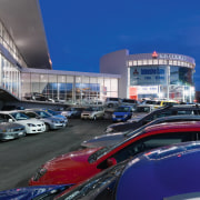 A view of the Mitsubishi Motors building. - automotive design, building, car, city, city car, luxury vehicle, metropolis, metropolitan area, mid size car, blue, black