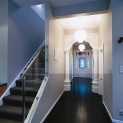 view of the renovated hallway featuring dark stained architecture, ceiling, daylighting, floor, handrail, home, interior design, property, real estate, stairs, structure, blue