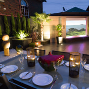 view of the outdoor dining area featuring alluminium home, lighting, black