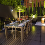 view of the outdoor dining area featuring alluminium flower, furniture, lighting, outdoor structure, patio, plant, table, black, brown