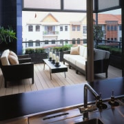 view of the outdoor entertainment area featuring cane architecture, daylighting, furniture, interior design, living room, table, window, black
