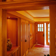 view of the entrance way featuring cobbled flooring, architecture, beam, ceiling, daylighting, door, floor, flooring, hardwood, home, house, interior design, lighting, real estate, room, wall, window, wood, wood stain, red, brown
