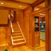 view of the stairway featuring timber flooring and cabinetry, ceiling, door, floor, flooring, hardwood, home, interior design, laminate flooring, lighting, lobby, real estate, stairs, wood, wood flooring, wood stain, brown, orange
