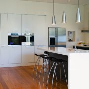 A view of the kitchen, wooden flooring and cabinetry, countertop, floor, flooring, furniture, hardwood, interior design, kitchen, laminate flooring, room, table, wood, wood flooring, gray