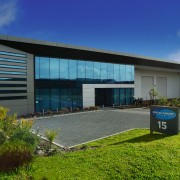 Exterior view of commericlal building, showing concrete walls architecture, commercial building, corporate headquarters, facade, home, house, property, real estate, sky, blue