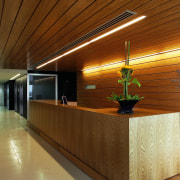 Office reception area with timber desk, wall and architecture, ceiling, floor, flooring, interior design, lobby, real estate, wood, brown