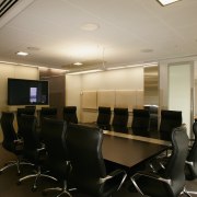 Office boardroom with mahogany table and black chairs. ceiling, conference hall, furniture, interior design, office, black