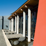 Exterior view of library building with waterway, small architecture, column, sky, structure
