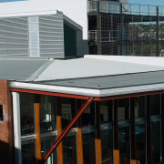 Exterior view of building showing grey roofing, and architecture, building, city, daylighting, facade, house, metropolitan area, residential area, roof, urban area, window, black