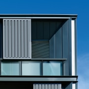 Exterior view of apartment building showing metal titanium architecture, building, commercial building, daylighting, elevation, facade, home, house, line, residential area, roof, siding, sky, window