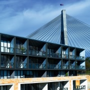 Exterior view of apartment building showing metal titanium architecture, building, condominium, corporate headquarters, facade, house, real estate, roof, sky, structure, teal, black