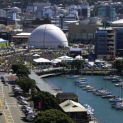 View of Wellington waterfront's Waitangi Park, with large aerial photography, boat, city, cityscape, daytime, downtown, harbor, marina, metropolis, metropolitan area, sky, skyline, urban area, water, black