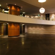 Lobby area of apartment building featuring limestone tiles architecture, ceiling, floor, flooring, hardwood, interior design, lighting, lobby, wood, brown