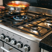 view of this kitchen featuring white granite benchtop, cookware and bakeware, gas stove, kitchen appliance, kitchen stove, black, gray