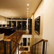 A view of a home designed by Streeter ceiling, floor, flooring, furniture, handrail, interior design, lighting, room, table, wood, orange, brown