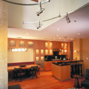 view of the lounge/dining area featuring  african architecture, ceiling, daylighting, interior design, light fixture, lighting, living room, lobby, room, table, gray