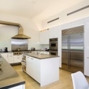 view of this kitchen featuring  travertie flooring, countertop, interior design, kitchen, real estate, white