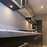 view of this kitchen manufactured and designed by architecture, countertop, daylighting, glass, interior design, kitchen, lighting, room, under cabinet lighting, gray, black