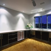 Kitchen with dark cabinetry and white benchtop, with cabinetry, ceiling, countertop, floor, flooring, interior design, kitchen, lighting, room, gray