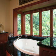 view of the bathroom featuring travertine and granite bathroom, countertop, daylighting, estate, home, interior design, real estate, room, window, wood, red, brown