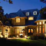 view of this house featuring timber high divided building, cottage, estate, evening, facade, historic house, home, house, landscape lighting, lighting, mansion, property, real estate, residential area, sky, villa, black, blue