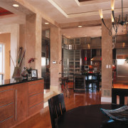 A view of the kitchen and didning areas. ceiling, dining room, interior design, lobby, real estate, room, brown, black