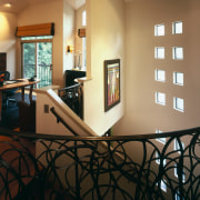 view of the spiral staircase, which feature iron ceiling, dining room, floor, flooring, furniture, handrail, hardwood, home, house, interior design, light fixture, lighting, living room, lobby, real estate, room, table, wall, window, wood, black, brown