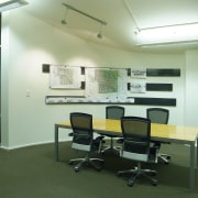 A view of a cream coloured painted wall. classroom, furniture, institution, interior design, office, real estate, green, white