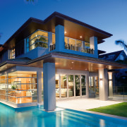 A view of a home by Santa Barbara architecture, elevation, estate, facade, home, house, lighting, mansion, mixed use, property, real estate, residential area, resort, swimming pool, villa, window, blue