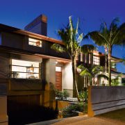 A view of a home by Santa Barbara architecture, arecales, building, cottage, estate, facade, home, house, lighting, night, palm tree, property, real estate, residential area, sky, villa, brown, blue