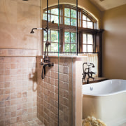 A close up view of the shower. - bathroom, floor, flooring, home, interior design, plumbing fixture, room, tile, wall, brown