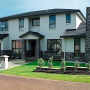 Large two storey home with cream cladding, stone cottage, estate, facade, home, house, neighbourhood, property, real estate, residential area, roof, siding, suburb, window, yard, gray, black