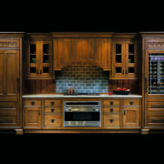 view of this kitchen featuring stained wood cabinetry, cabinetry, cupboard, furniture, hardwood, kitchen, wood, wood stain, black, brown