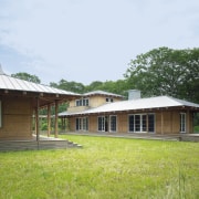 exterior veiw of this vaction home nestle in cottage, estate, facade, farmhouse, grass, home, house, land lot, landscape, property, real estate, roof, white