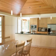 view of the kitchen/dining area featuring camara slate architecture, beam, ceiling, countertop, daylighting, estate, floor, flooring, hardwood, home, house, interior design, kitchen, laminate flooring, living room, property, real estate, room, wood, wood flooring, orange, brown