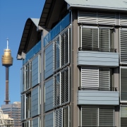 view of the saunders wharf apartments featuring crips architecture, building, city, commercial building, condominium, facade, house, metropolitan area, residential area, structure, urban area, window, gray, black, teal