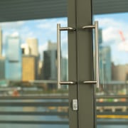 view of the lobby featuring door hardware by glass, metropolitan area, window, gray, brown