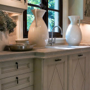 A view of a kitchen by Design Galleria bathroom accessory, cabinetry, chest of drawers, countertop, drawer, furniture, home, interior design, kitchen, room, sink, table, wood stain, brown, gray