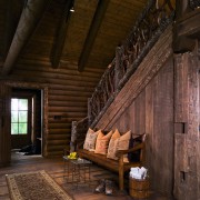 view of the lounge/entrance in this vacation home interior design, log cabin, wood, brown, black