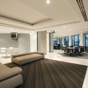 view of the breakput area featuring couches, tables ceiling, floor, flooring, interior design, living room, penthouse apartment, real estate, room, orange