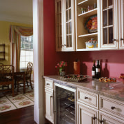 A view of a kitchen designed by Cornerstone cabinetry, countertop, cuisine classique, furniture, home, interior design, kitchen, room, shelving, window, red, brown