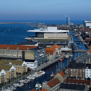 An aerial view of the opera house. - aerial photography, bird's eye view, city, cityscape, harbor, marina, passenger ship, port, sea, ship, sky, urban area