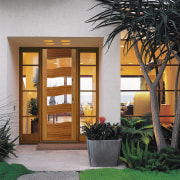 Entranceway of home showing timber and glass front architecture, courtyard, door, facade, home, house, real estate, window, gray
