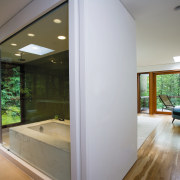 View of the bathrom featuring recessed bath, floor architecture, ceiling, daylighting, estate, floor, flooring, home, house, interior design, real estate, wall, window, wood flooring, gray